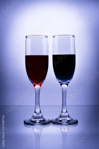 Two flute  glasses with liquor and vignette - tall shot