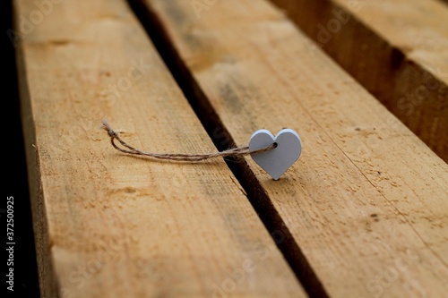 Heart shaped pendant on wooden beams.