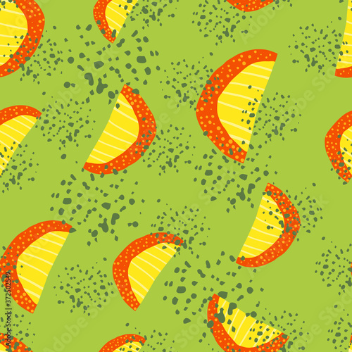 Random summer seamless pattern with fruit slices silhouettes. Yellow and red color fruit figures on green background with splashes.