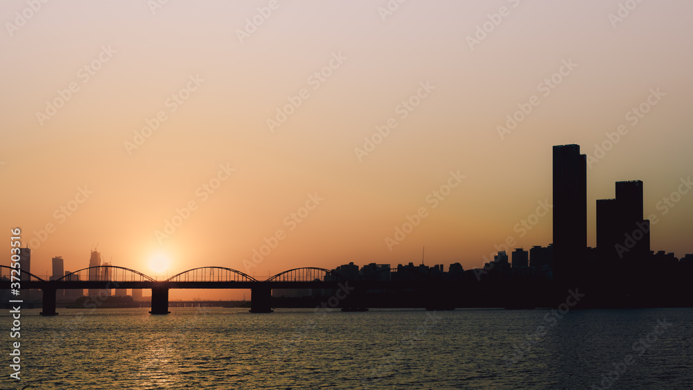 sunset with silhouette city and bridge background at seoul korea