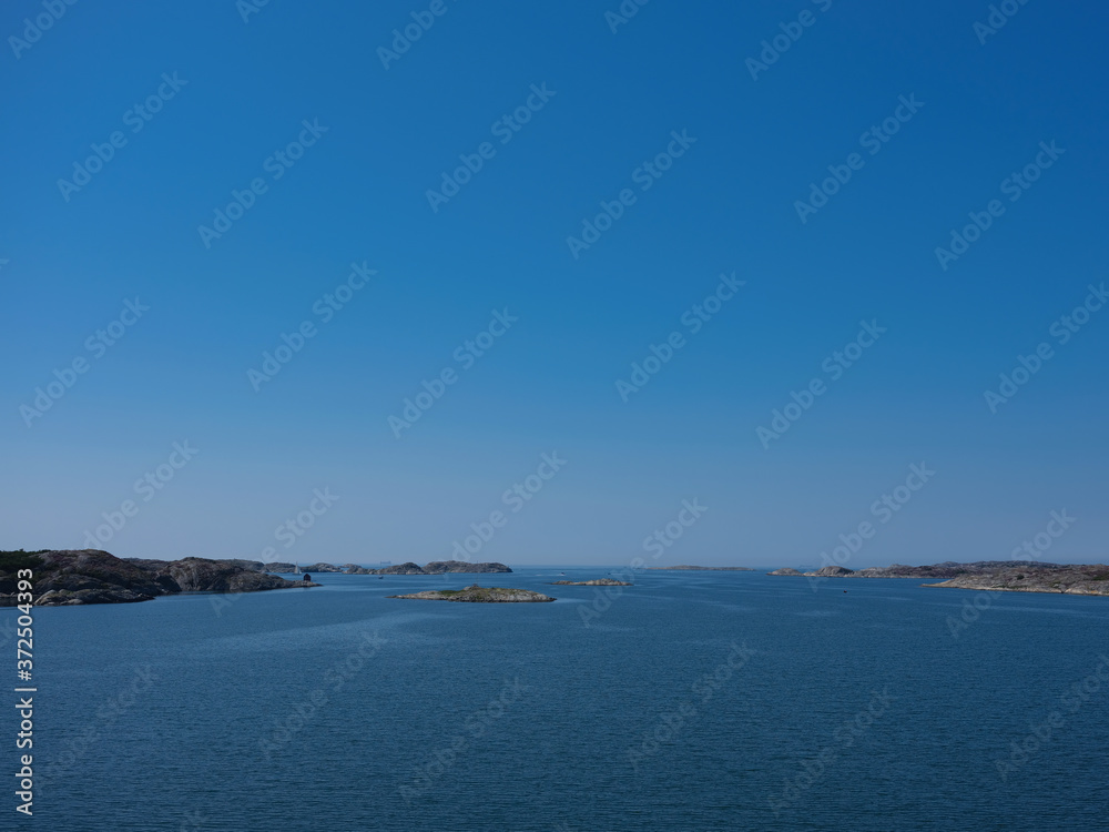 Seascape photo with small rocky islands and blue sky. Seascape photo with small rocky islands and blue sky.