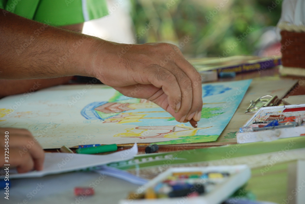 Man draws paints on the table. Man draws paints on the table.
