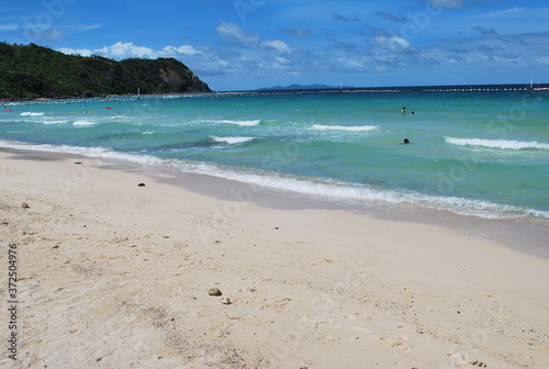 A beach with little waves in the blue sea.