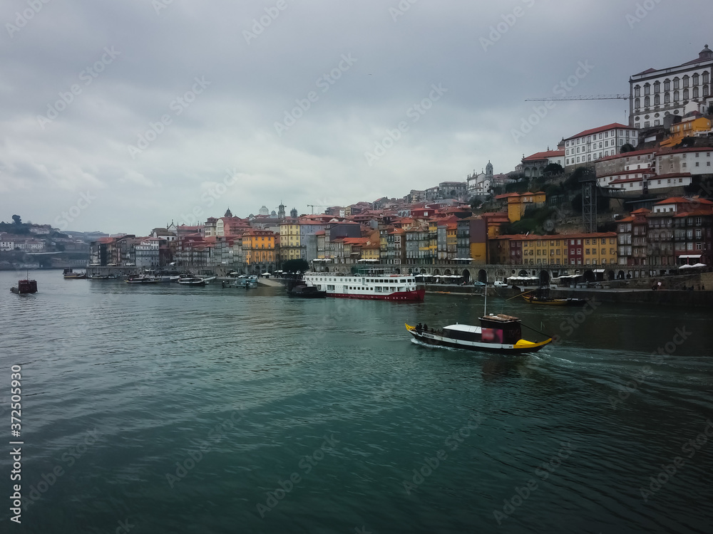 Panoramic view of the Douro River and the city of Porto, in a cold and gray winter sunset.