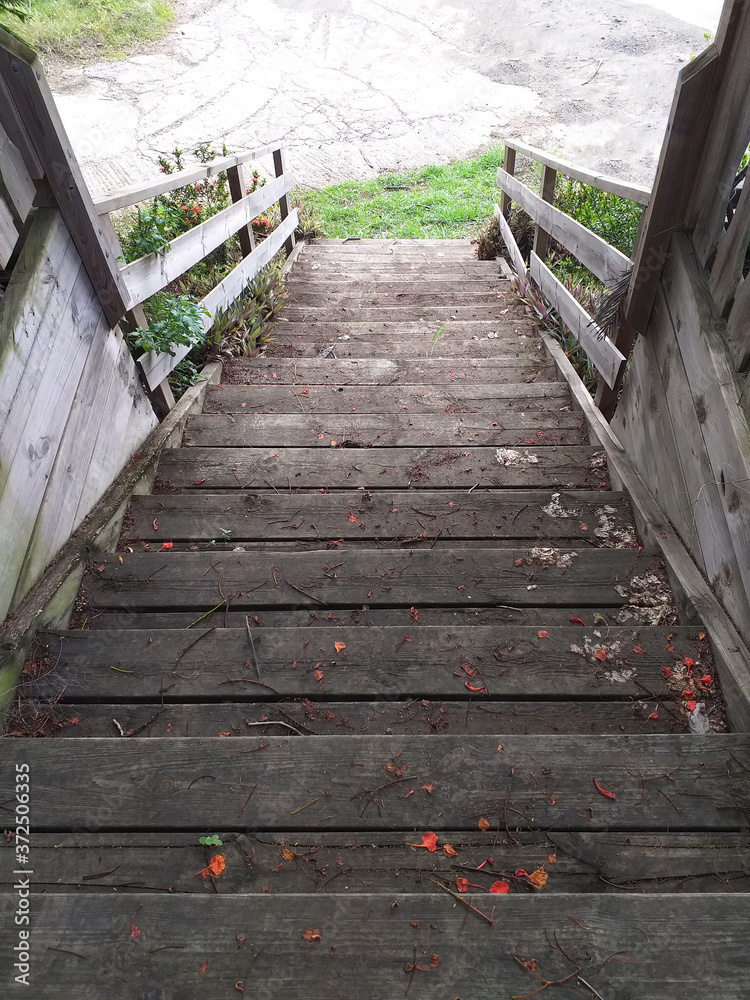 Obraz premium Perspective view of wooden stairs with steep incline. Detail of Caribbean and tropical architecture.