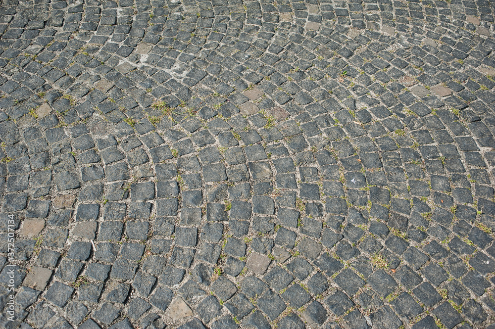 Fototapeta premium Old textured cobblestones in the city