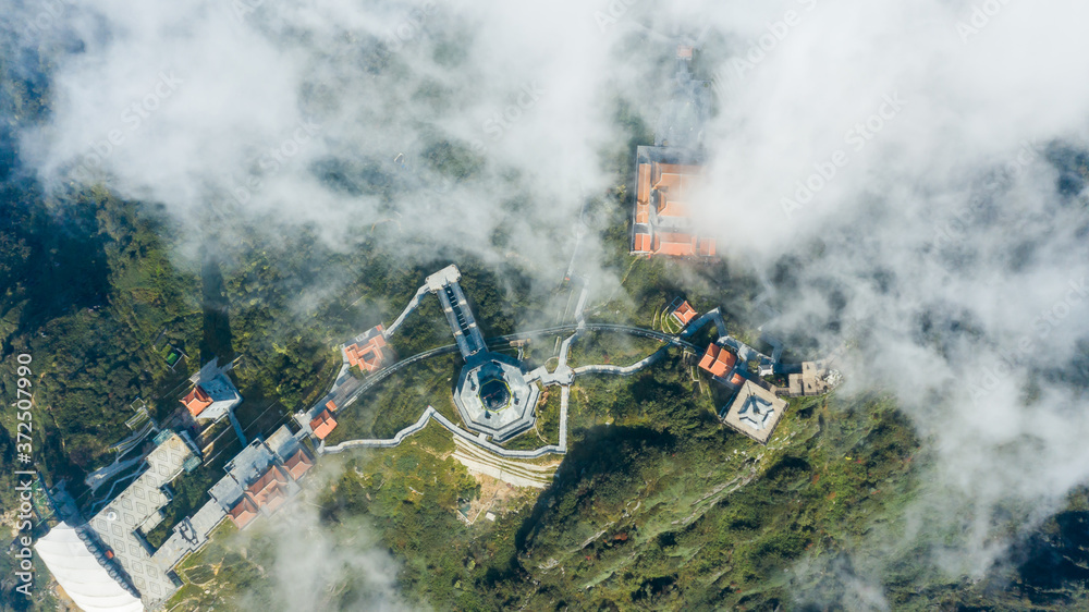 Fototapeta premium Aerial view architecture of the temple and pagoda on the top of the Fansipan mountain with a beautiful natural scenic of Sapa, Lao Cai, Vietnam
