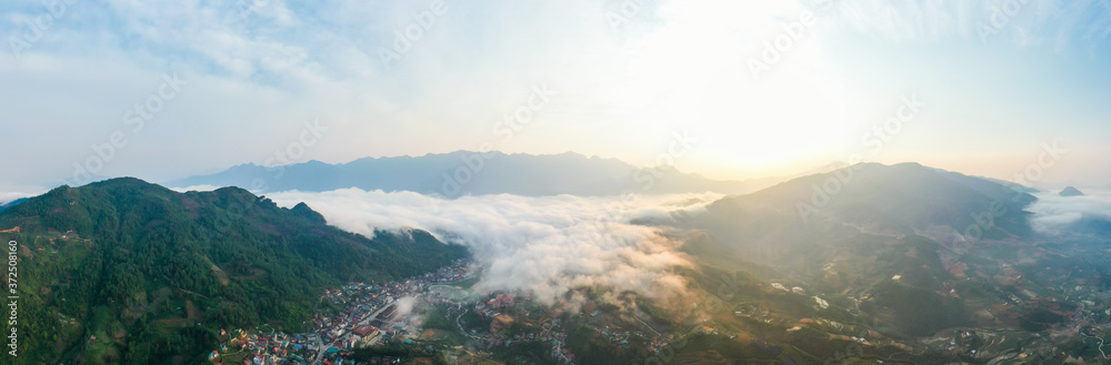 Aerial view of panorama landscape at the hill town in Sapa city, Vietnam with the sunny light and sunset, mountain view in the clouds