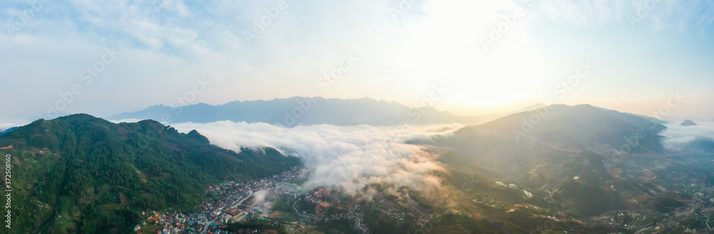 Aerial view of panorama landscape at the hill town in Sapa city, Vietnam with the sunny light and sunset, mountain view in the clouds Aerial view of panorama landscape at the hill town in Sapa city, Vietnam with the sunny light and sunset, mountain view in the clouds