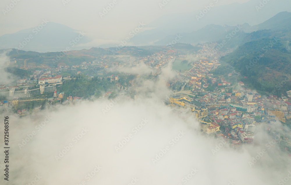 Aerial view of panorama landscape at the hill town in Sapa city, Vietnam with the sunny light and sunset, mountain view in the clouds