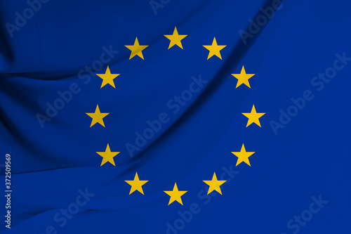 The flag of the European Union on fabric texture background. Flag image for design on flyers, advertising.