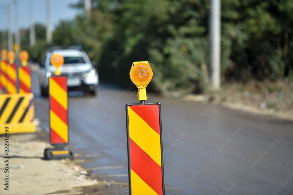 Yellow warning lights in a hazard zone during construction road works