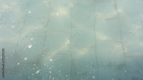 Water in the fountain and tiles on the bottom.