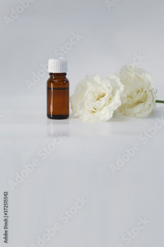 Eustoma extract (remedy) bottle with fresh Eustoma flower isolated white
