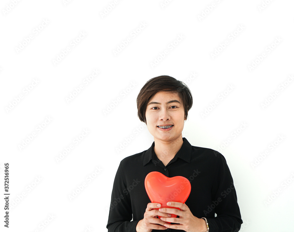 Asian sporty woman short hair holding red heart abstract love balloon white copy space Asian sporty woman short hair holding red heart abstract love balloon white copy space