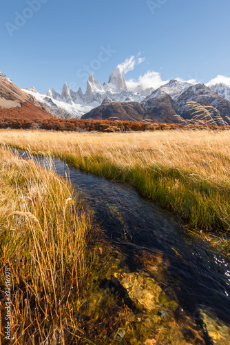 Golden autumn scenery  beautiful snow-capped mountains and blue sky and white clouds. Travel in Argentina.