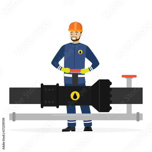 Happy oilman turns a pipeline valve. Oil industry and worker or engineer in special clothing and helmet. Gas or oil pipe,