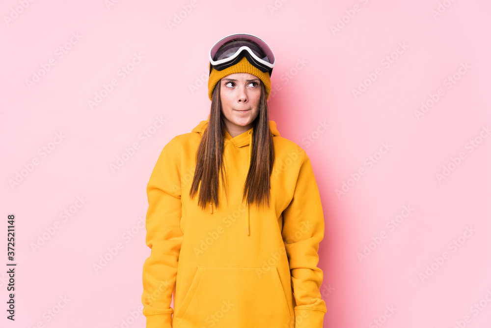 Young caucasian skier woman isolated confused, feels doubtful and unsure. Young caucasian skier woman isolated confused, feels doubtful and unsure.