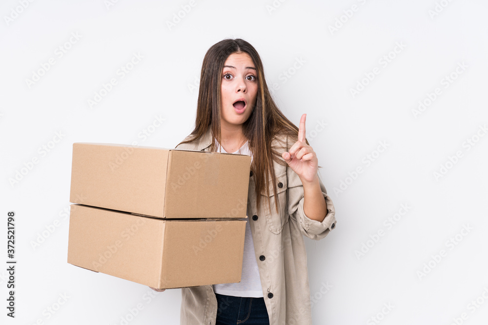 Young caucasian woman moving to a new home having an idea, inspiration concept. Young caucasian woman moving to a new home having an idea, inspiration concept.