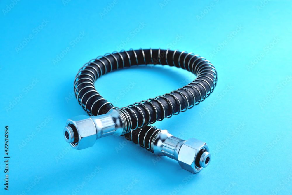 brake hose with a protective sheath for a truck, car accessories, auto parts, car brake system parts on a blue background