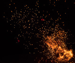 fire flames with sparks on a black background, close-up