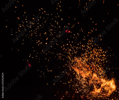 fire flames with sparks on a black background, close-up