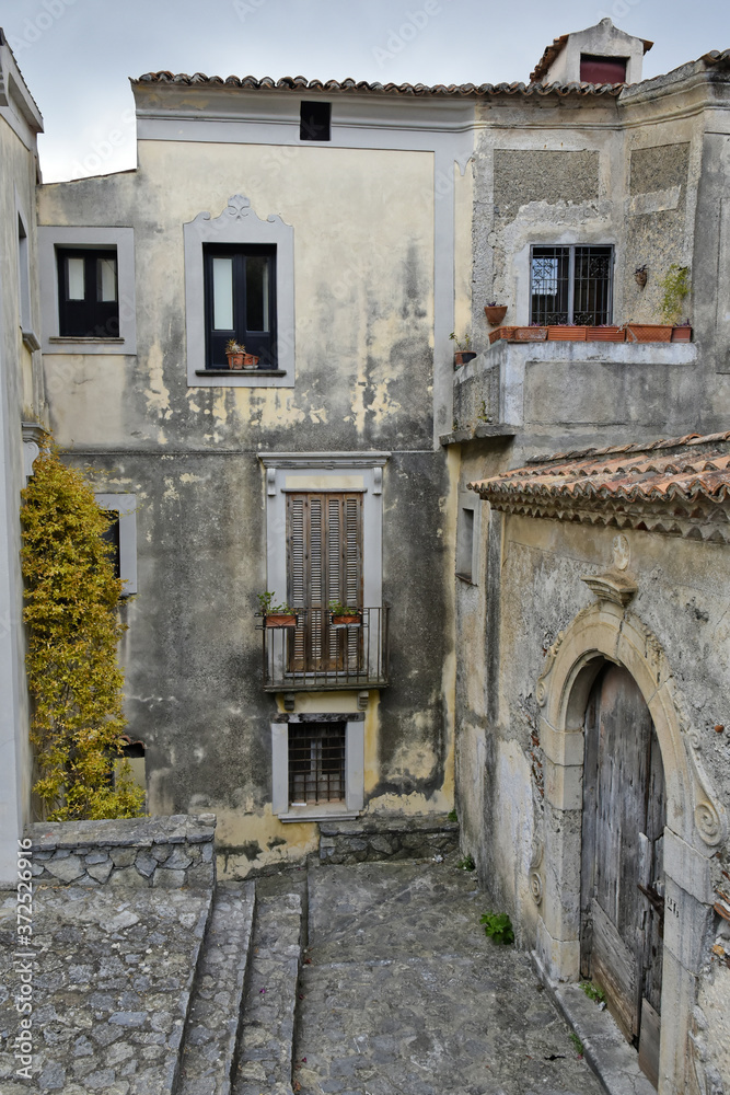 Fototapeta premium A narrow street among the old houses of Scalea, a rural village in the Calabria region, Italy.