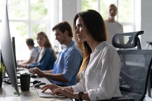 Woman working at computer in an office Free Download Woman working at computer in an office - GFXLoad