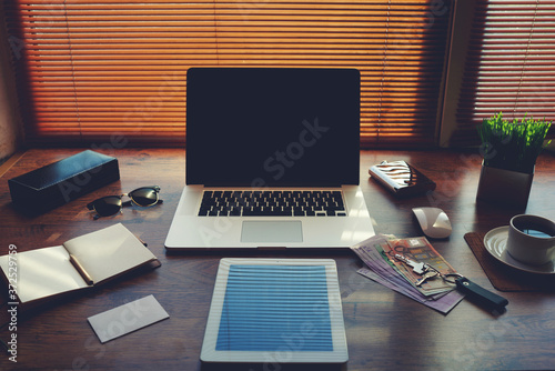 Mock up of successful person with luxury accessories and work tools, cup of coffee, sunglasses, notepad, money, envelope, digital tablet and laptop computer, hipster office workplace desktop