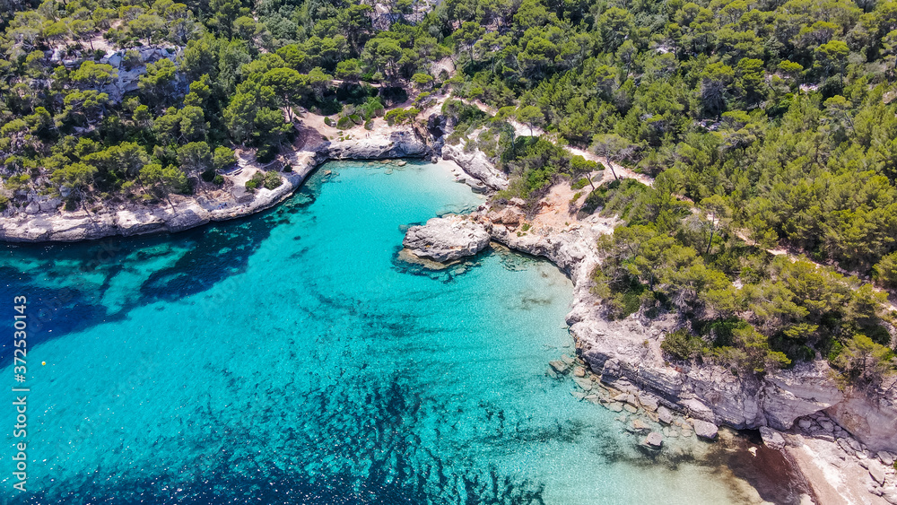 Beautiful aerial view of Mediterranean white sand beach and turquoise water in Menorca Spain, Cala Mitjana, aerial top view drone photo