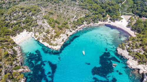 Beautiful aerial view of Mediterranean white sand beach and turquoise water and a boat in Menorca Spain, Cala Macarella, aerial top view drone photo photo