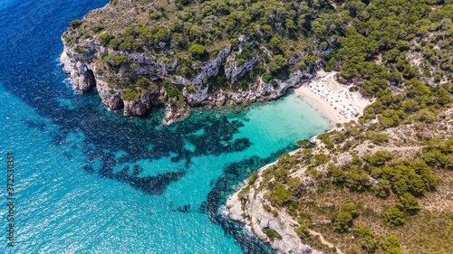 Beautiful aerial view of Mediterranean white sand beach and turquoise water and a boat in Menorca Spain, Cala Macarella, aerial top view drone photo © Ada