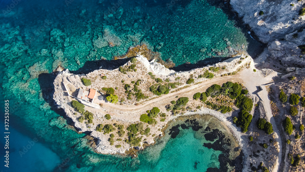 Aegina coastline with blue water, little bay on a beautiful Greek island seen from a drone, aerial top view