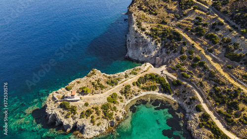 Fototapeta Naklejka Na Ścianę i Meble -  Aegina coastline with blue water, little bay on a beautiful Greek island seen from a drone, aerial top view