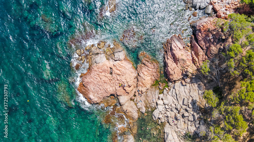 Aerial view of beautiful coastline in Mediterranean coast of Spain, Costa Brava. Panorama of Rocks on the coast in beautiful summer day. Beautiful beach with turquoise sea, boats, holiday destination 