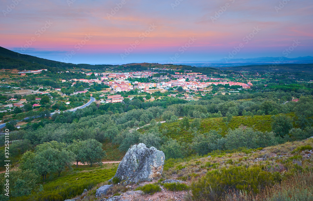 Aerial view of Jarandilla de la Vera at sunset, with the full moon rising. Extremadura. Spain