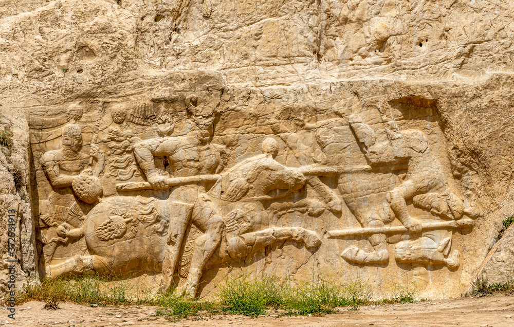 Iran, Naqshe-e-Rustam, near Persepolis in Iran, beside  the Tombs of King Darius and King Xerxes. Reliefs of Sasanian king Bahram II fighting against an enemy.