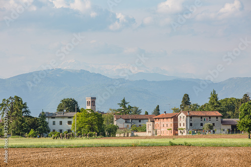 Panoramic view of old buildings in the small italian village with mountains background. Oleis, Italy photo