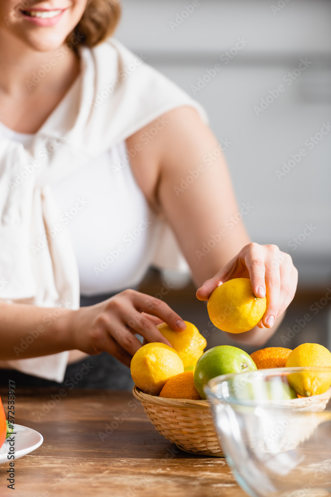 cropped view of woman holding lemons in hands
