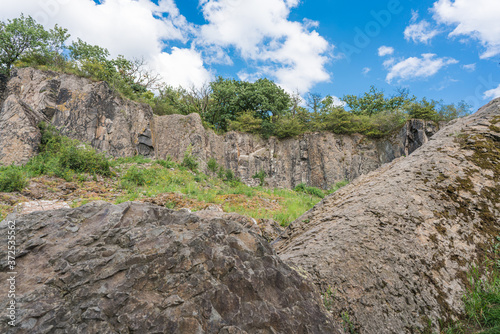 Panoramic view of boulders in front of a rock wall of the Stenzelberg. photo