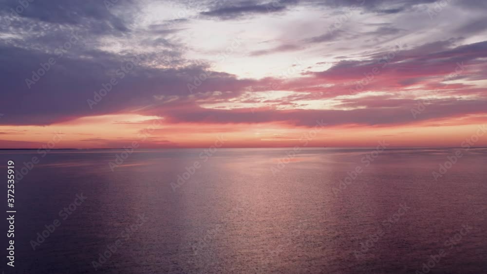 Incredible peaceful sunrise with colorful sky, flying down to Water with Bird Incredible peaceful sunrise with colorful sky, flying down to Water with Bird