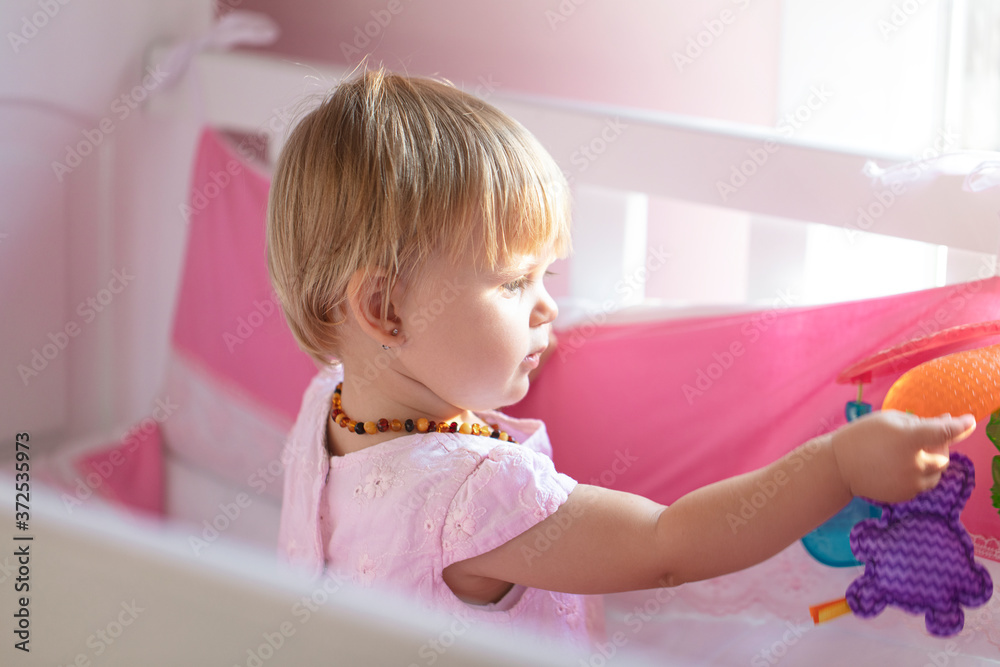 Beautiful little baby girl in playpen. Cute boy playing with colorful toy.
Beautiful little baby girl in playpen. Cute boy playing with colorful toy.