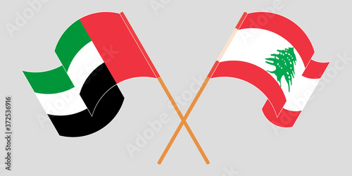 Crossed and waving flags of Lebanon and the United Arab Emirates