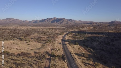 4K aerial drone video of African savanna hills, large red granite boulders range near B1 highway south of Windhoek in central highland of Namibia, southern Africa