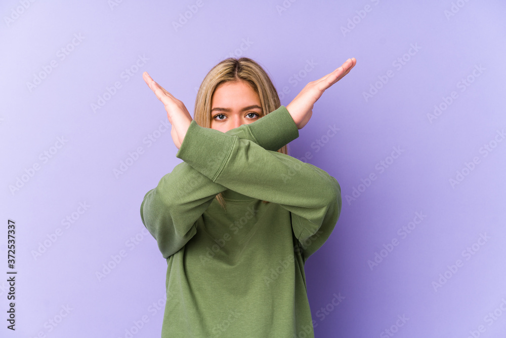 Young blonde caucasian woman isolated keeping two arms crossed, denial concept. Young blonde caucasian woman isolated keeping two arms crossed, denial concept.
