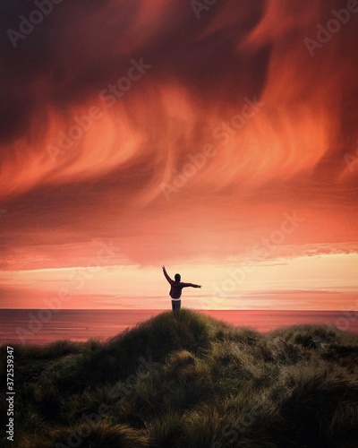 silhouette of a man jumping on the sunset