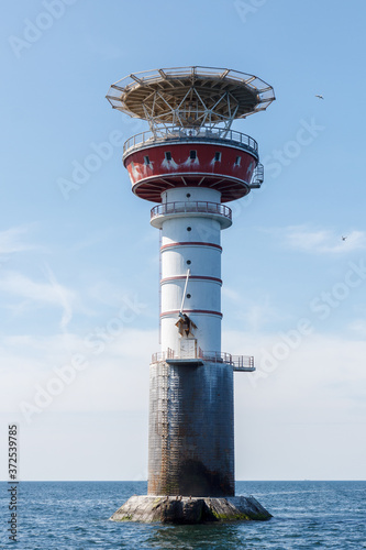 Irbe lighthouse in Baltic sea. Built in 1979 in Mihaila Michaels bank, claimed by Soviet media as the largest nuclear-powered lighthouse in USSR. Formerly inhabited, has a helicopter platform on the photo