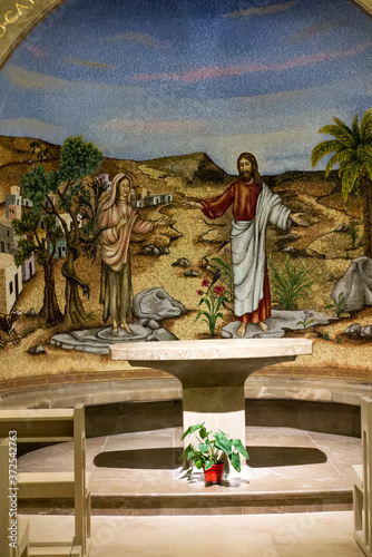 Magdala, Israel, January 26, 2020: Side altar in the church in Magdala on the Galilee Lake (Tiberiacn) with a mosaic depicting Jesus and Mary Magdalene photo
