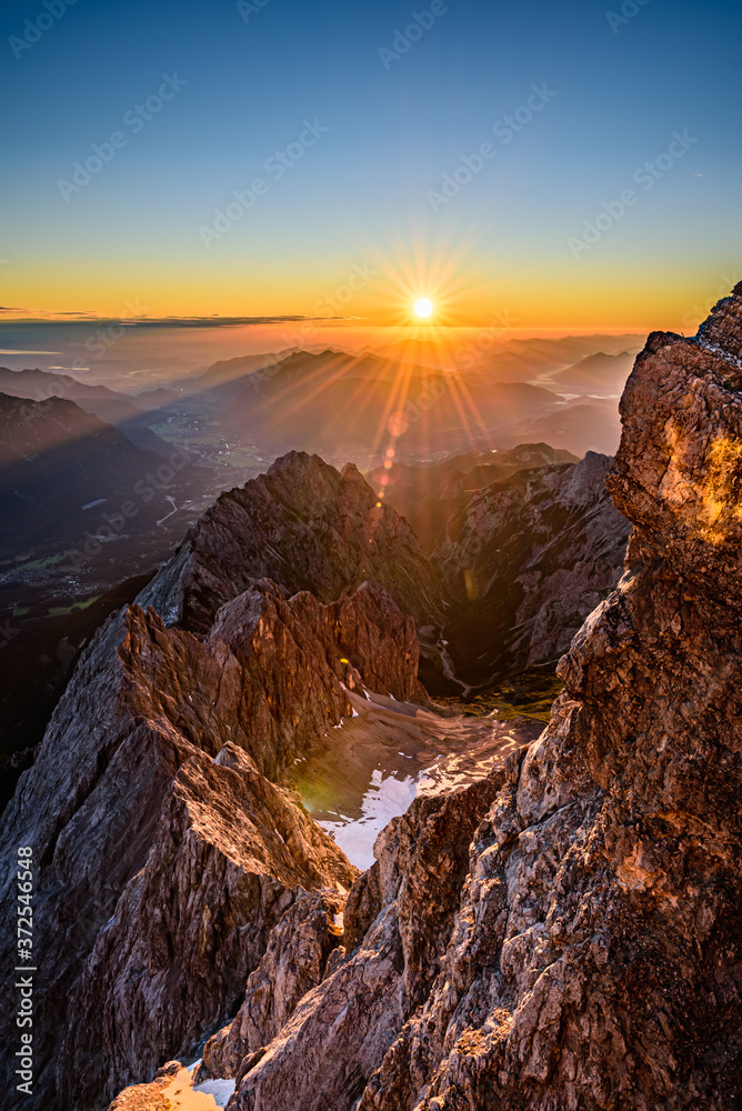 A beautiful and colorful sunrise on the summit of the highest mountain in Germany, Zugspitze at 2962m.