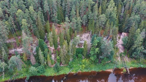 Aerial Shot of the Cliff of Sietiniezis Rock, Latvia. Gauja National Park, Pine Forest Tourist Trail With Pathwalk Near Sandstone Cliffs. Peaceful Landscape With Gauja River and White Sandstone. photo